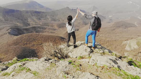 Man And Woman Hikers On Top Excited And Victorious