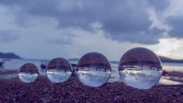 Raining On Four Crystal Balls On The Beach.