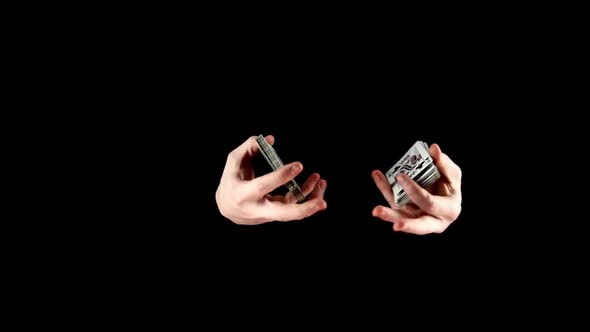 Talanted Magician Showing His Trick with Cards, Like Two Fans on Black