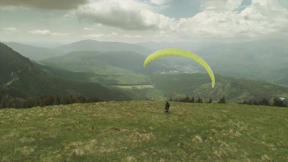 Man With A Paraglider Chased By A Drone