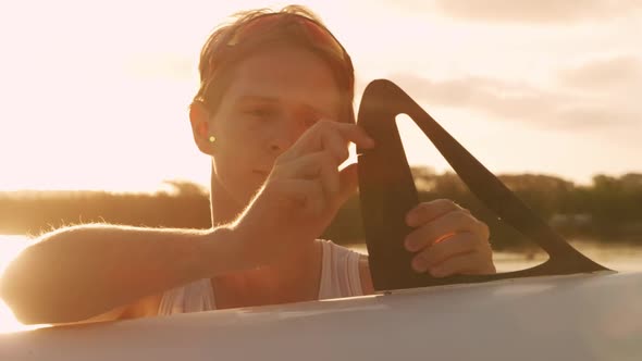 Male rower preparing boat before practice