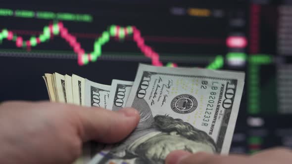 Trader Counting Dollars Watching Chart