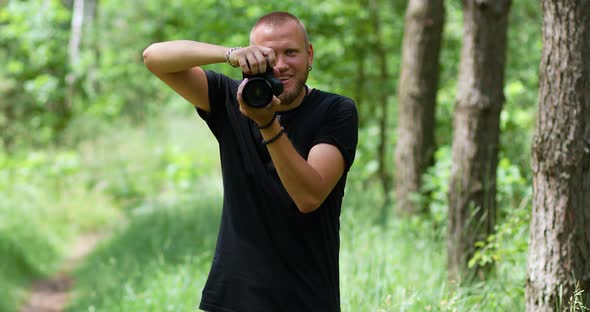 Male Photographer Take Photo with a Professional Camera Outdoor