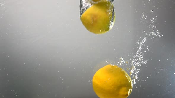 Whole Lemon Drops Under Water. Isolated