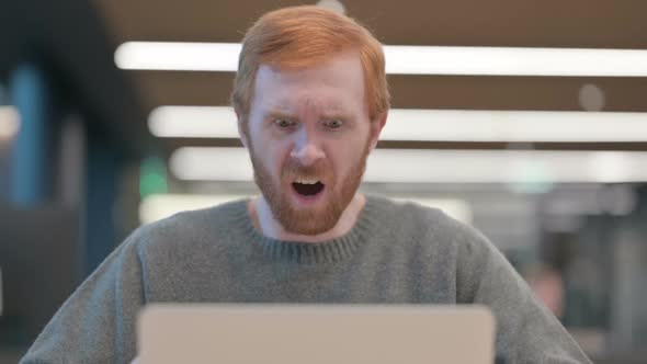Portrait of Man Reacting to Loss on Laptop
