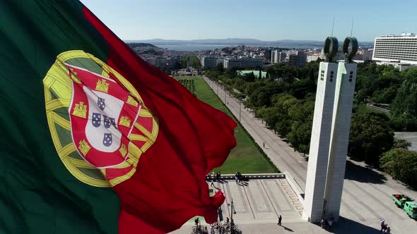 Close Up Aerial View of Portugal Flag Waving in the Wind on Eduardo VII Park Lisbon