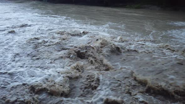 River flowing after heavy rain. Water stream After strong rain. Dirty and turbulent water after rain