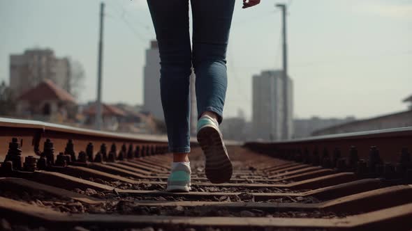 Legs On Train Railroads.Woman Walks On Railroad Tracks.Tourist Walking Railroads Track Rail Railway