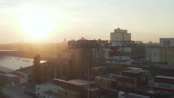 Port in Early Morning Sunrise with Cargo Containers and Cranes, Aerial Foward