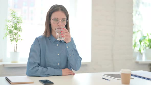 Woman Drinking Water at Work