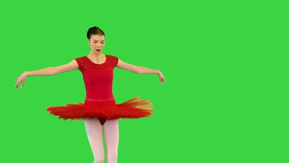 Young Ballerina in Red Classical Tutu Performs Fouette on a Green Screen Chroma Key