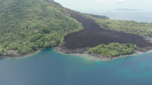 Aerial: flying over Banda Islands active volcano Gunung Api lava flow Indonesia 