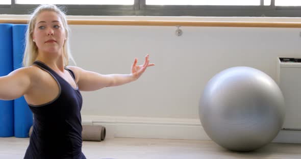 Woman doing yoga in fitness gym 4k