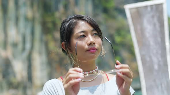 4K Portrait of Young Asian woman sitting on the boat passing beach lagoon in summer vacation