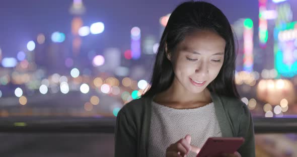 Young Woman Use of Mobile Phone at Night