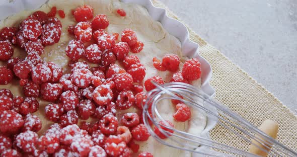 Red berries on tart with whisker and rolling pin 4k