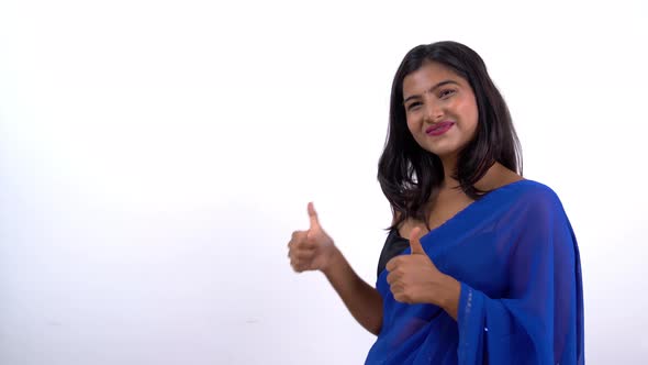 Indian woman pointing on left in saree for product placement, ads, etc