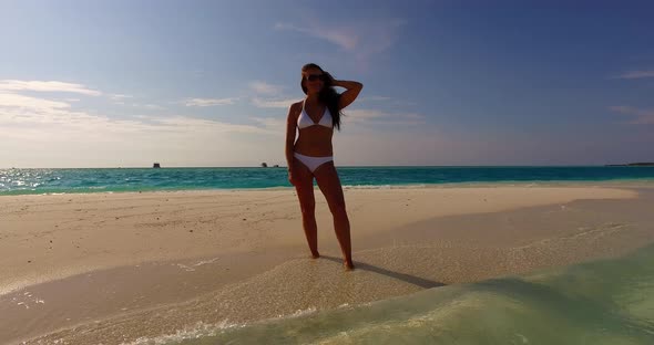 Modern Smiling Girl Traveling Enjoying Life at The Beach on Summer White Sandy and Blue Background 