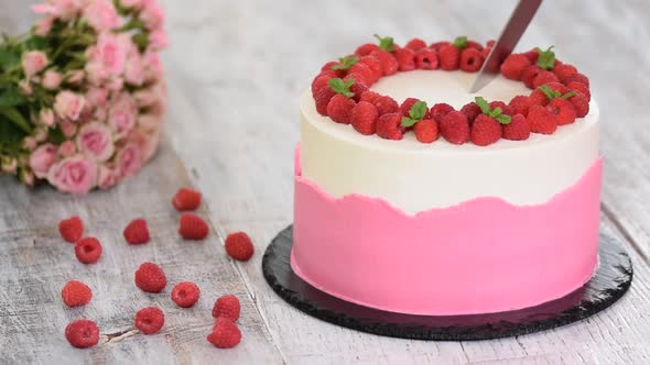 Cake with whipped pink cream, fresh raspberry and mint.	