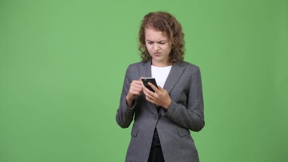 Young Stressed Businesswoman Using Phone and Getting Bad News