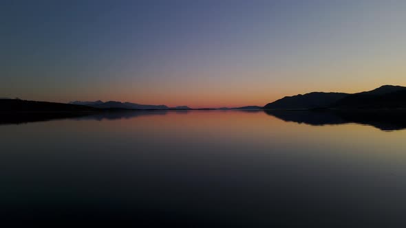 Silhouette Of Senja Island With Mirror Reflection At Sunset In Norway. - wide shot