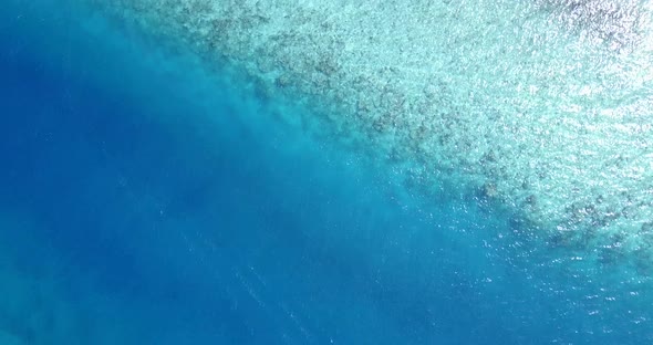 Wide flying abstract view of a summer white paradise sand beach and aqua turquoise water background 