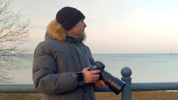 Professional Male Photographer Photographs a Seascape