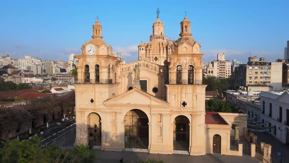 Cinematic aerial dolly in shot toward the statue of Christ in between two clock towers, historic mon