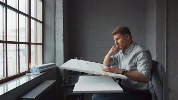 Thinking young businessman at work