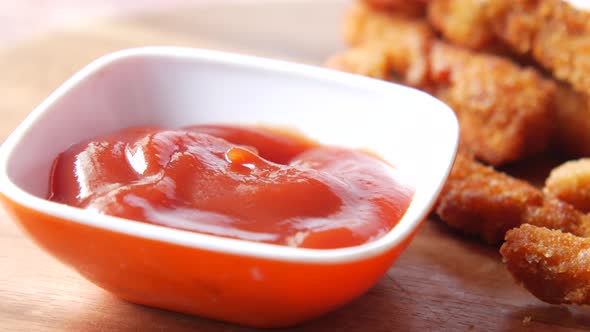 Close Up of Chicken Stripe and Sauce on Table