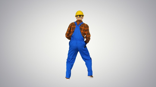 Construction worker in helmet dancing on gradient background.