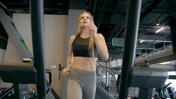 Young Sexy Woman Is Running Very Intensive Training on Treadmill.
