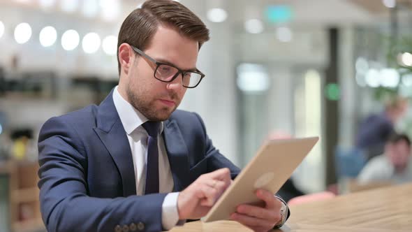 Young Businessman Using Digital Tablet at Work 