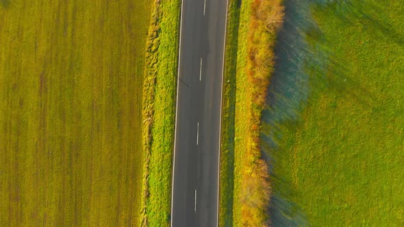 drone flight over open country road with some traffic