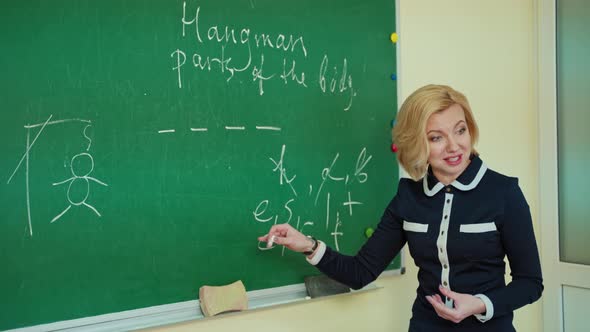 Pedagogue teaches near the board