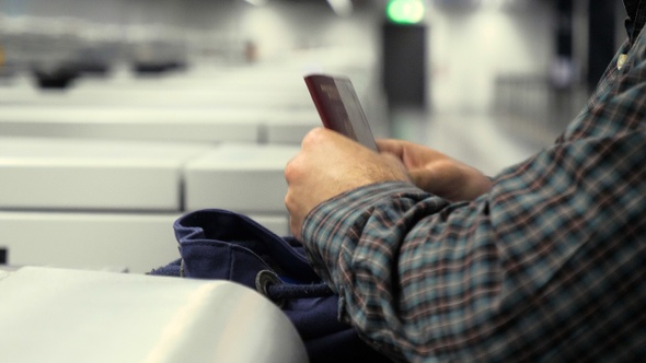 Airport Check-In: man taking out passport from his backpack