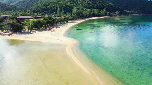 Aerial flying over texture of paradise tourist beach holiday by turquoise ocean and white sand backg