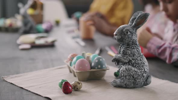 Close Up of Easter Bunny Figurine and Eggs