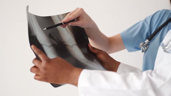 Two Doctors Studying Xray Image in Bright Office