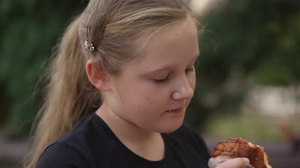 Fat Girl Eating s Bun at the Street