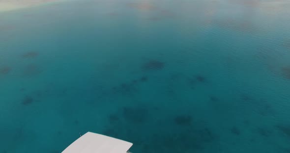 Aerial view of two boats embarked in the middle of the tropical ocean in Maldives