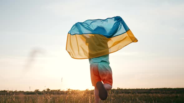 Cute Little Boy  Ukrainian Patriot Kid Running with National Flag on Open Area Field