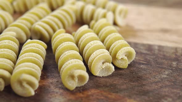 Uncooked pea fusilli pasta. Green italian vegetable macaroni. Macro