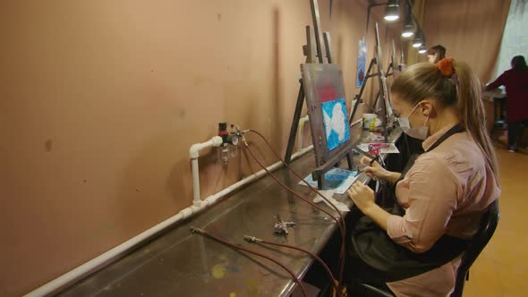 Woman Artist Learns to Paint with Airbrush with Acrylic Dye Paper and Easel