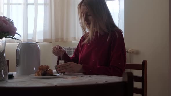 Woman having breakfast at the morning.