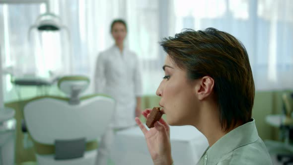 Girl Eats Chocolate, Dentist Looks at Her Disapprovingly