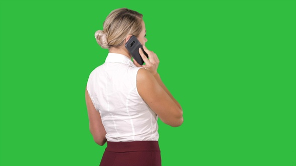 Woman talking on the phone on a Green Screen, Chroma Key.