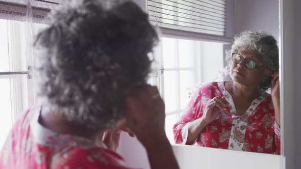 A senior african american woman spending time at home taking care of herself social distancing in q