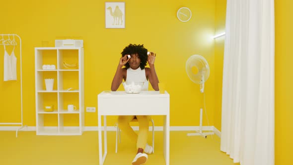 Black Woman Is Playing With Marshmallow In Yellow Interior