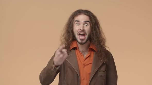 Wild and Carefree Heavymetal Fan Curlyhaired Guy Shouting Impressed Praising Nice Work Staring